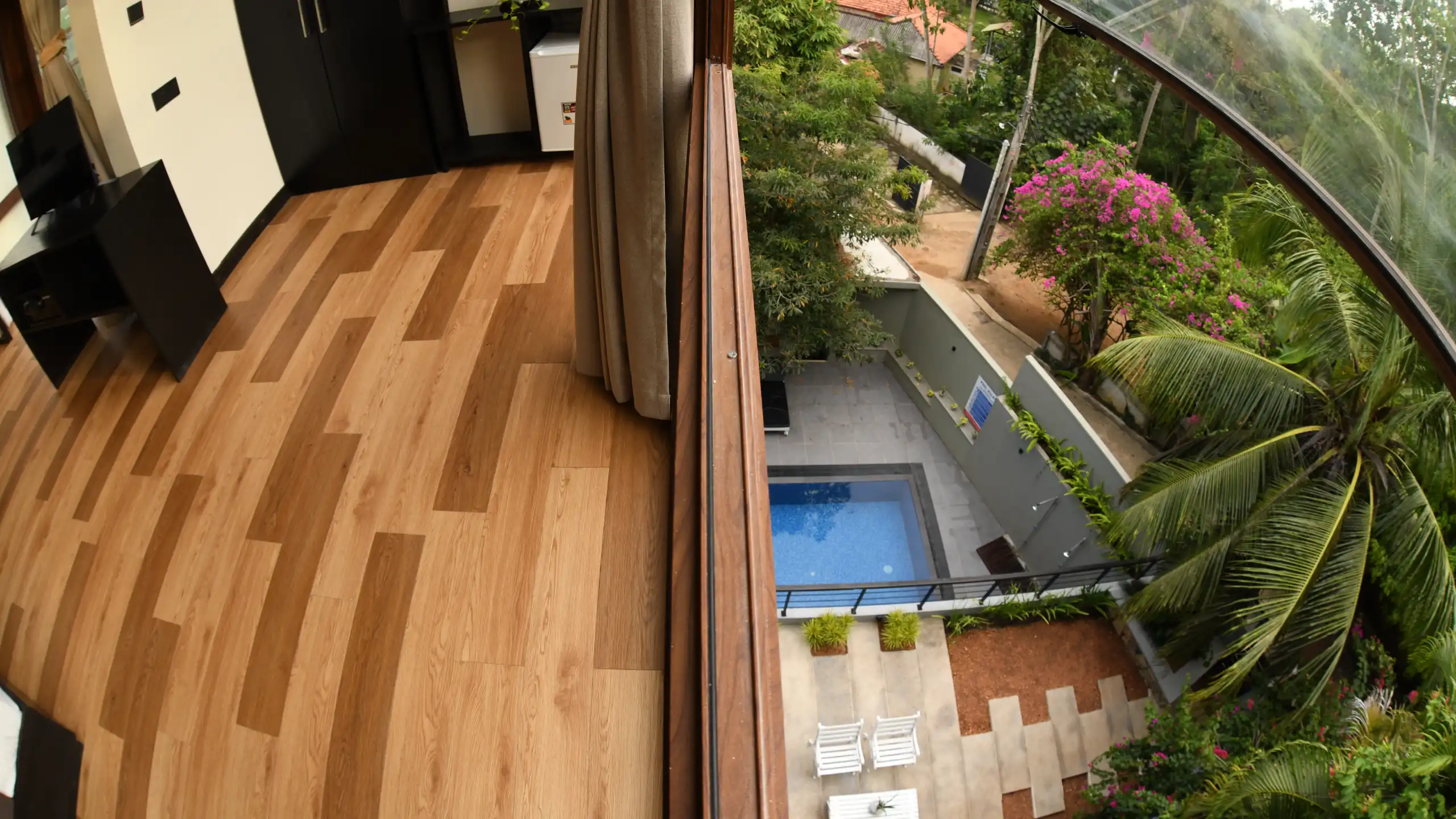 Hiriketiya accommodation room with balcony and pool view at Hiriketiya Beach Resort