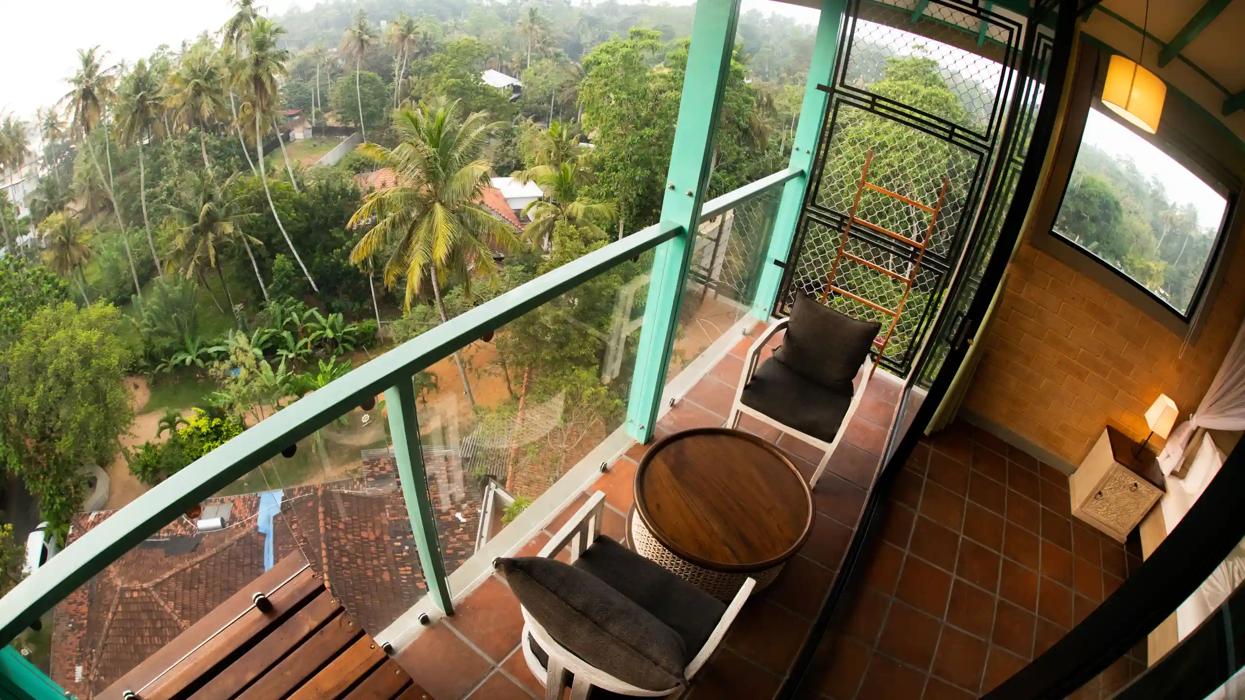 Hiriketiya accommodation balcony with tropical view at Hiriketiya Beach Resort