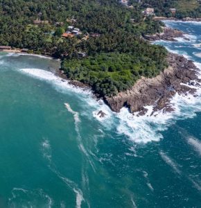 Aerial view of Hiriketiya Bay Sri Lanka coastline with turquoise ocean and tropical landscape