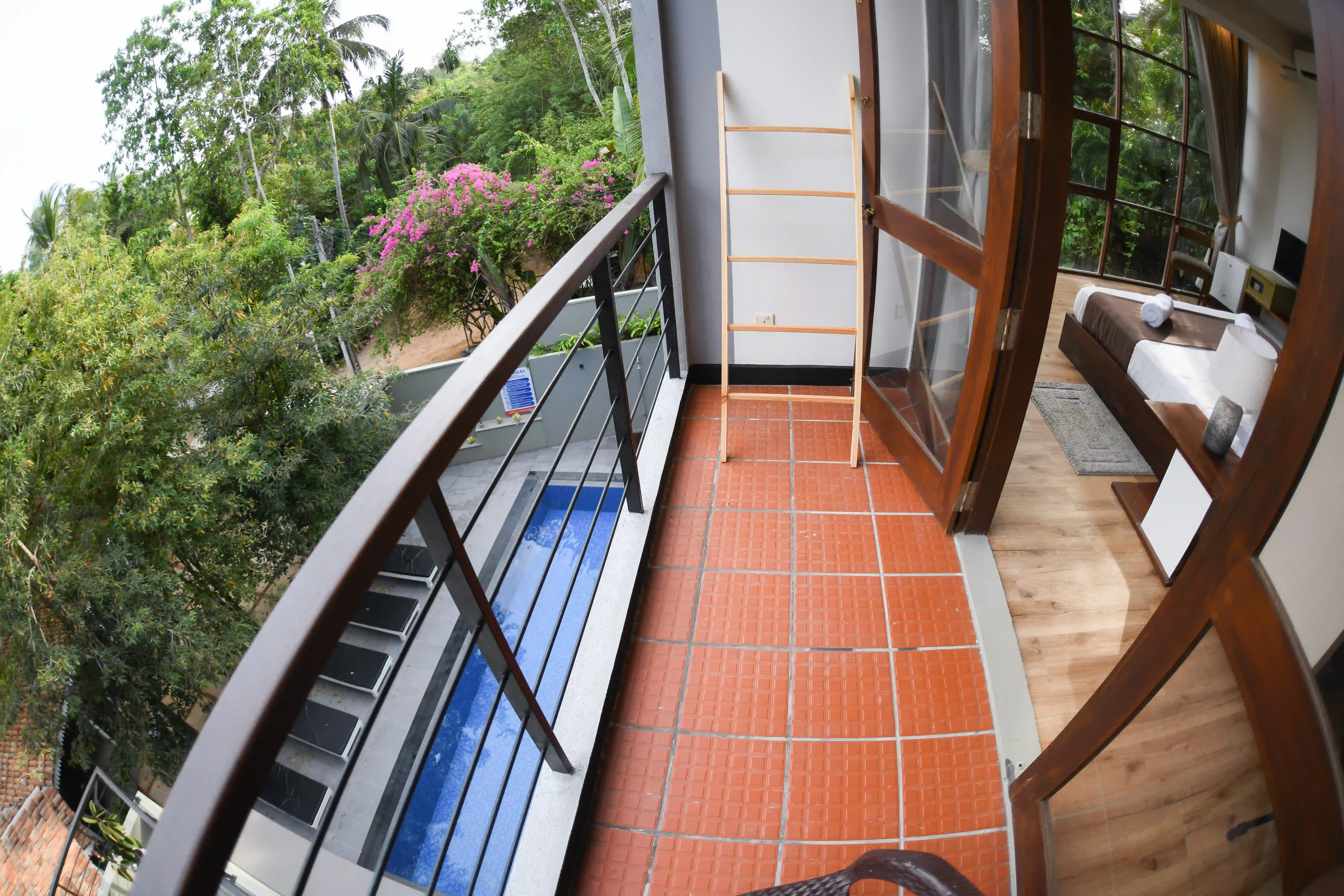 Private balcony with garden and pool view at Hiriketiya Beach Resort for comfortable Hiriketiya accommodation