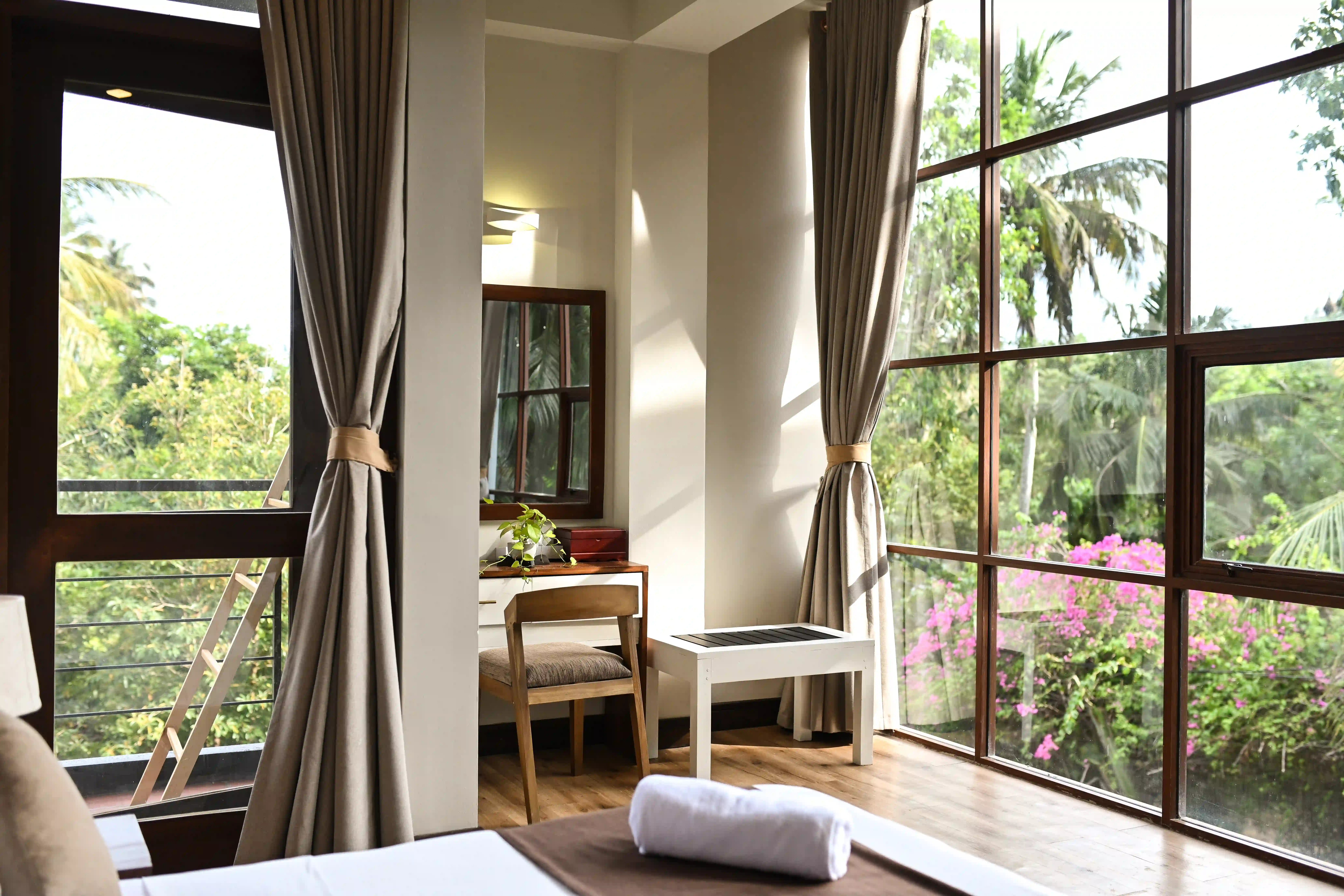 Bright room corner with large window and garden view at Hiriketiya Beach Resort for comfortable Hiriketiya accommodation