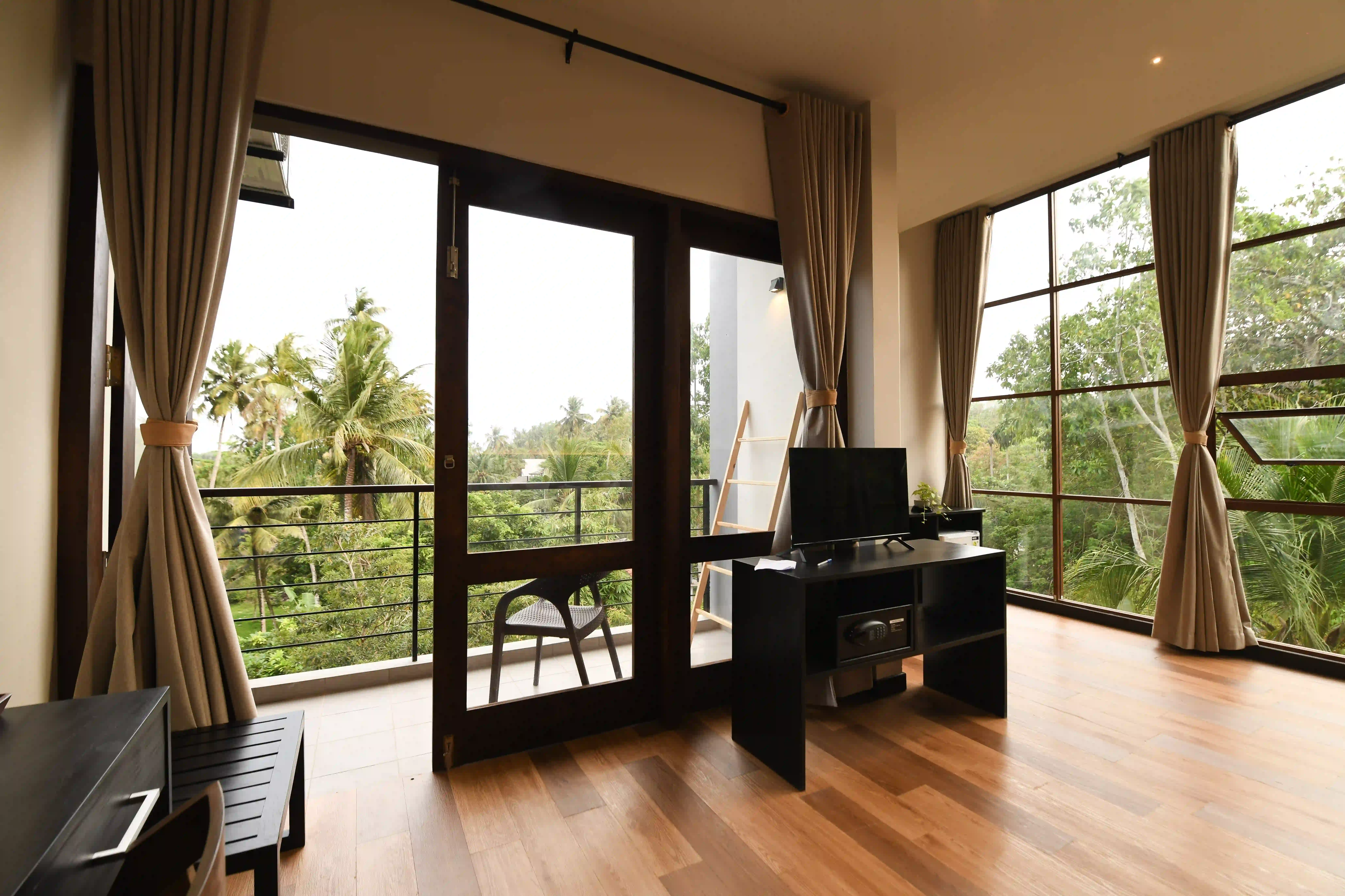 Spacious room with balcony and large windows at Hiriketiya Beach Resort for comfortable Hiriketiya accommodation