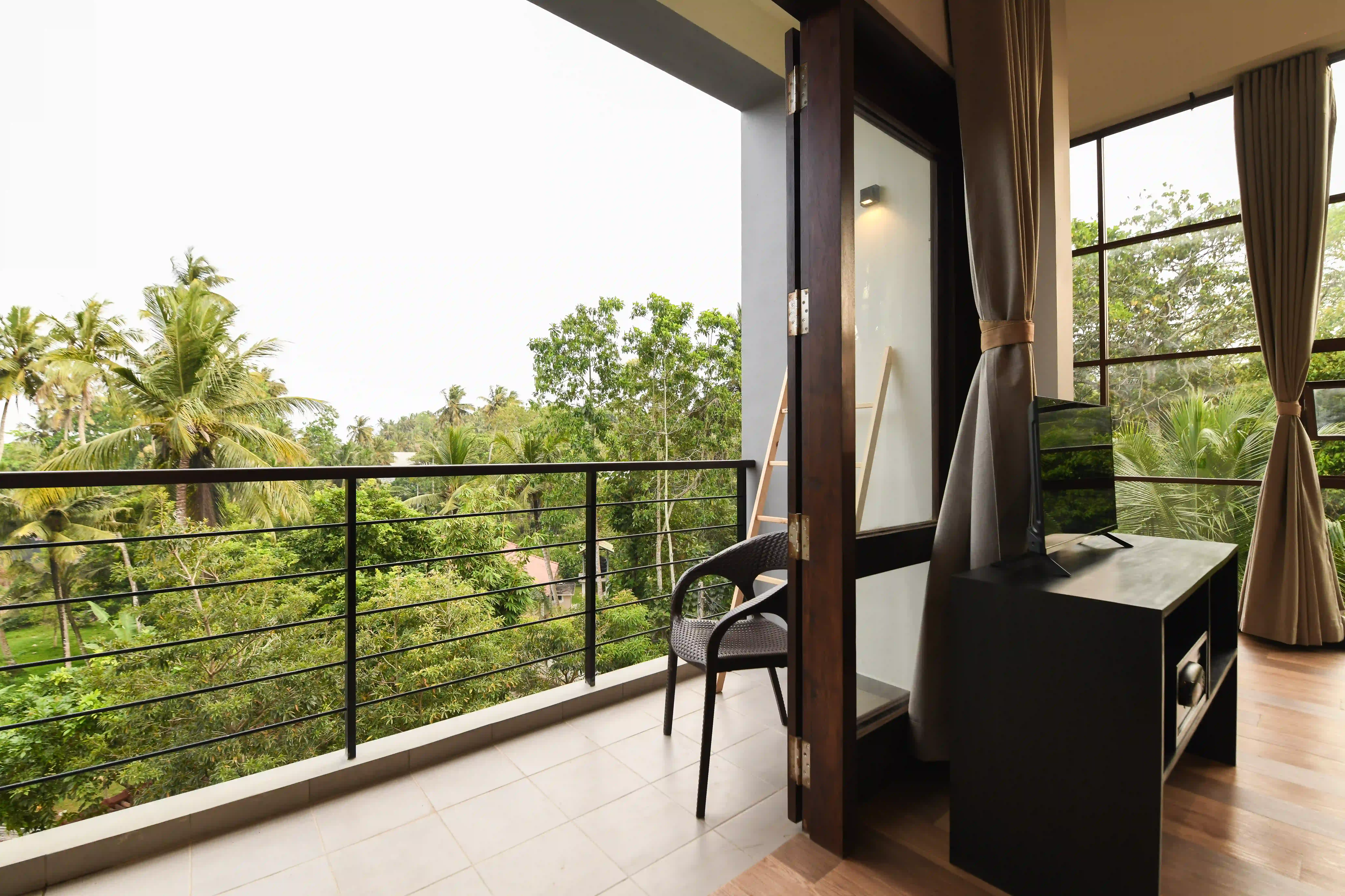 Spacious room with balcony and large windows at Hiriketiya Beach Resort for comfortable Hiriketiya accommodation