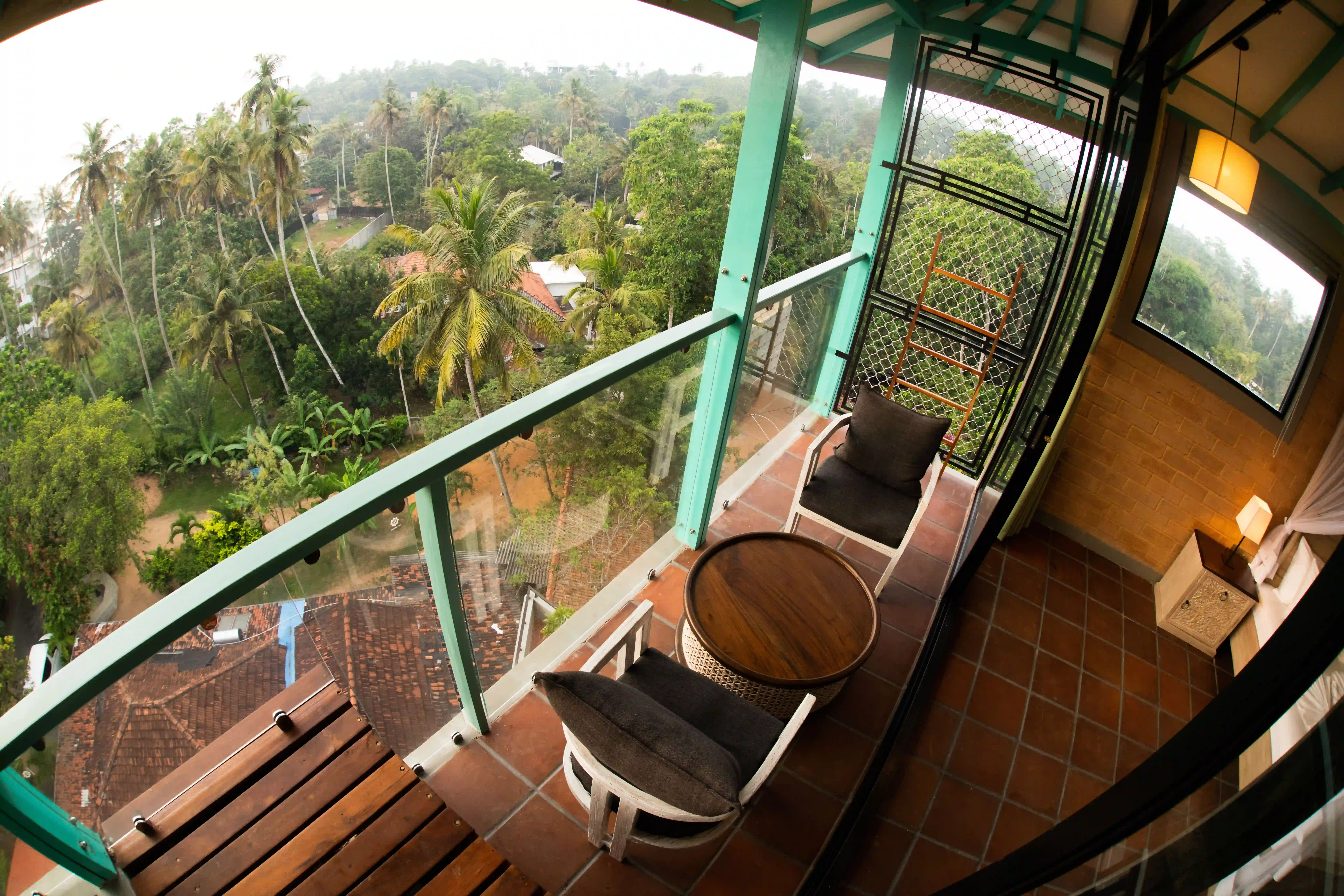 Private balcony seating area with table at Hiriketiya Beach Resort for comfortable Hiriketiya accommodation